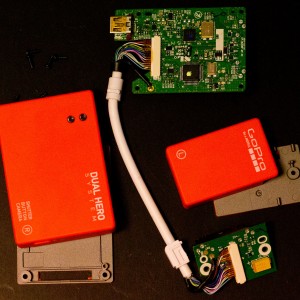 top: master bacpac, bottom right: slave bacpac, center: white cable connecting two bacpacs